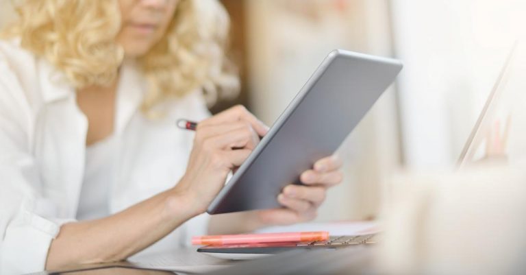 Businesswoman working and using tablet computer in office