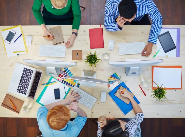 Above view of group of young designers working together at the table